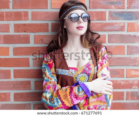 Portrait of Young hippie girl on brick wall background
