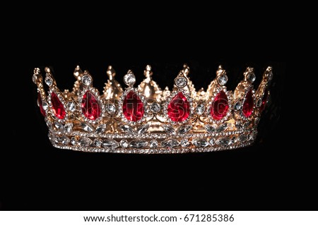Red crown with red gems isolated on black background Royalty-Free Stock Photo #671285386