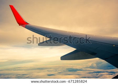 Morning sunrise with Wing of an airplane. Photo applied to tourism operators or backdrop. picture for add text message or frame website. Traveling concept