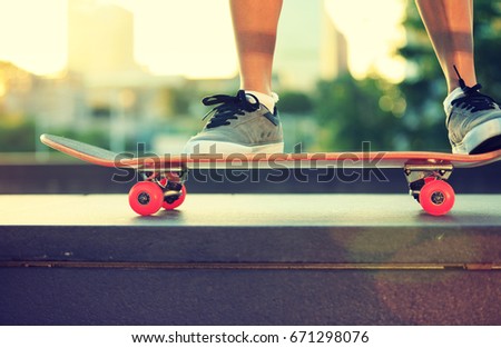 young woman skateboarder legs skateboarding at city