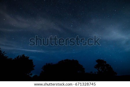 Deep blue sky astrophotography with trees 