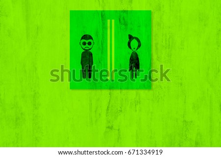 Black toilet sign on green wall background.