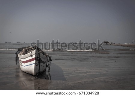  Focus is on a wooden fishing boat .placed in a beach . 