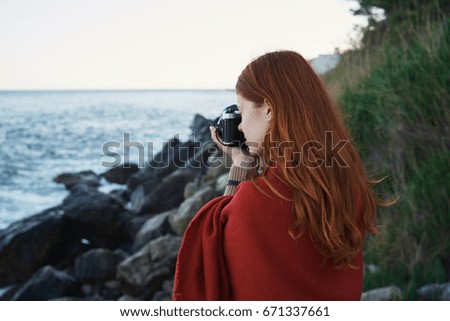 Woman taking pictures of the sea                               