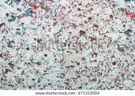 Old peeling paint on a concrete slab. Texture in turquoise, blue, pink pastel colors. Points, interspersions.