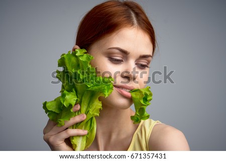 Woman with lettuce leaves                               