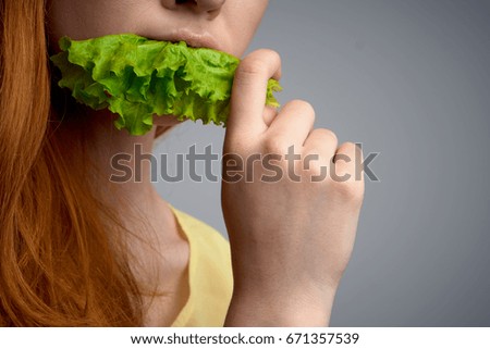 Woman with a salad leaf                               