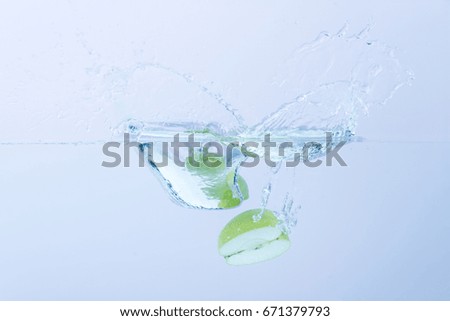 Green Apples splashing in water