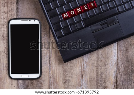 blank laptop keyboard, money buttons, wooden table - background with phone and copyspace