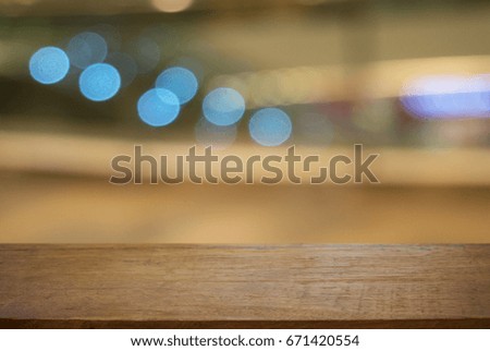 Empty dark wooden table in front of abstract blurred background of restaurant . can be used for display or montage your products.Mock up for display of product