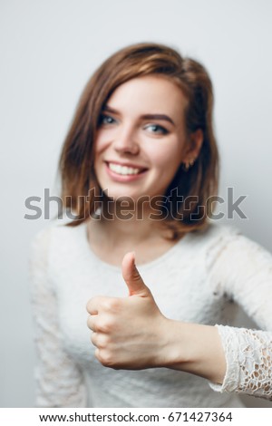 The girl is showing her thumb up, means everything is fine