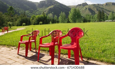 red plastic chairs and tables, preparing for the feast in the open air