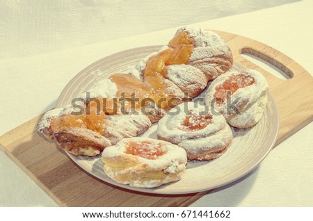 Appetizing homemade buns with orange fruit jam