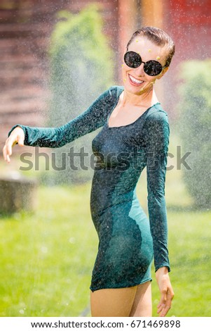 Running, dancing woman under the rain, in motion. Enjoy every moment concept