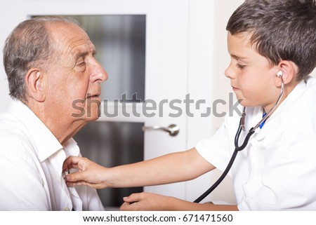 Kid examines his grandfather using stethoscope. Funny game