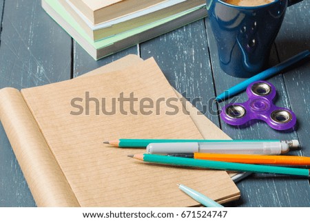 spinner, notebook and pencil on the table