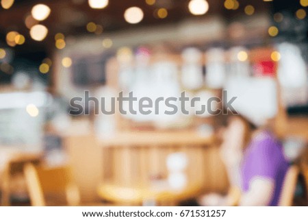 Blurred background vintage style. Coffee shop interior blur background  and people sitting on chair with bokeh background.