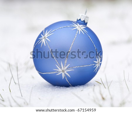 Christmas blue ball on a white snow