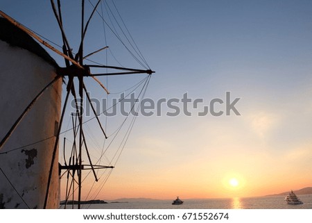 windmill sunset behind boat