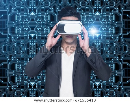 Visual reality concept.Young Asian man using Visual reality or VR headset and interacting with object.man getting experience using VR headset glasses.