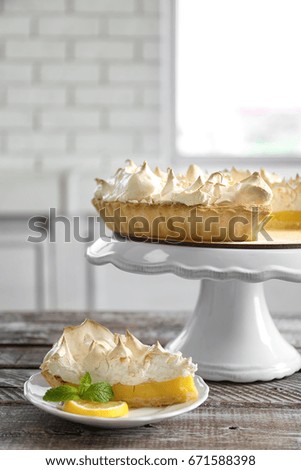 Composition with yummy lemon meringue pie on wooden table