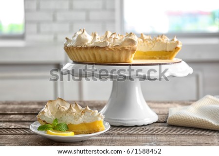 Composition with yummy lemon meringue pie on wooden table