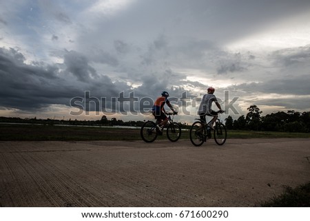 cyclist and Bicycle silhouettes on the dark background of sunsets. ride bicycle on sunset background.