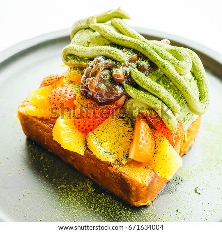 Sweet dessert bread toast with matcha ice cream and strawberry , orange in plate - Color filter Processing
