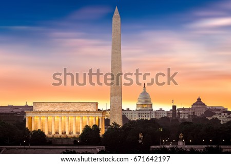 New dawn over Washington - with 3 iconic monuments illuminated at sunrise: Lincoln Memorial, Washington Monument and the Capitol Building. Royalty-Free Stock Photo #671642197