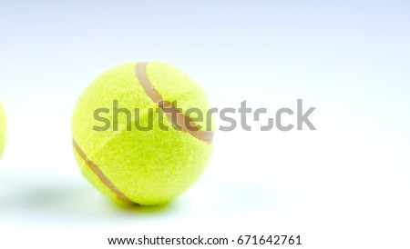 Closeup of tennis ball on white background. Selective focus and closeup fragment.