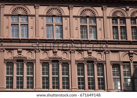 House facade at Market Square ('Marktplatz') in downtown Basel, closeup of a typical city building and its many windows - Canton of Basel, Switzerland