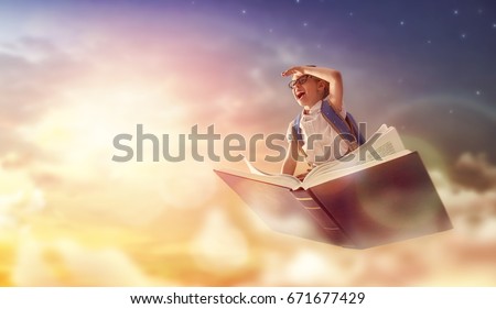 Back to school! Happy cute industrious child flying on the book on background of sunset sky. Concept of education and reading. The development of the imagination. Royalty-Free Stock Photo #671677429