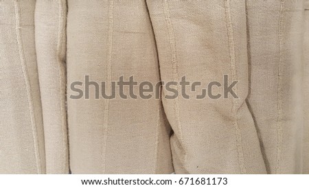 group of brown fabric roll selection / stock of grey fabric for fashion design business, raw material in garment manufacturing