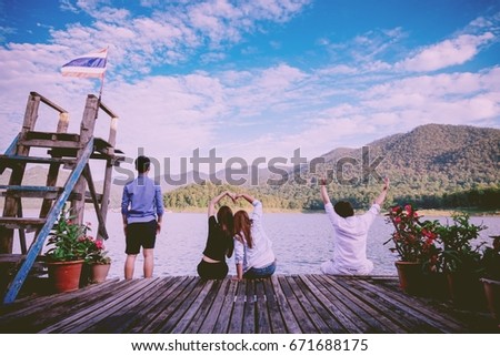 Men and women are making sing " I love you " in the lake at Mae Ngat dam ,Chiang Mai ,Thailand