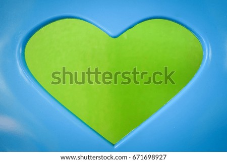 Blue plastic and heart isolated on cement floor