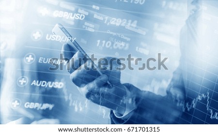 A man holding a smartphone, modern technology in trade, stock charts