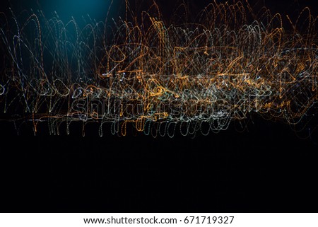 Orange and blue light painting lightpainting structure faded long exposure in dark night lights illuminated background in murcia in spain