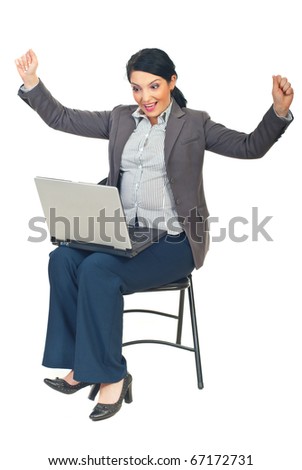Successful executive woman with laptop sitting on chair and cheering isolated on white background