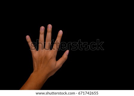 Left hand of man open the palm of the hand on Black wall