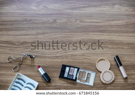 Creative flat lay of women cosmetics and accessories on wooden background, fashion beauty for woman concept with copy space for fill text