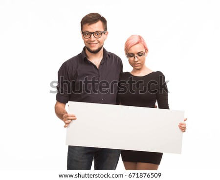 Young cheerful couple portrait of a confident businessman showing presentation, pointing paper placard background. Ideal for banners, registration forms, presentation, landings, presenting concept.