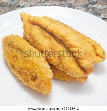 Typical food called Saltenha de Carne in Brazil. Salty, fried, stuffed with meat and spicy sauce. Common in regions of Brazil with Bolivian influence.