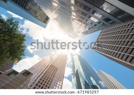 Upward view of skyscrapers against a cloud blue sky in the business district area of downtown Houston, Texas, US.