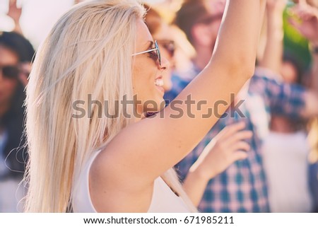 Caucasian girl dancing and having a good time at outdoor party