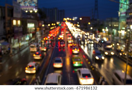 Low key image and blur soft focus to highlight the light and color of bokeh. Traffic conditions in the city Bangkok Thailand at night during the rush hour after work to return home on a rainy day. Royalty-Free Stock Photo #671986132