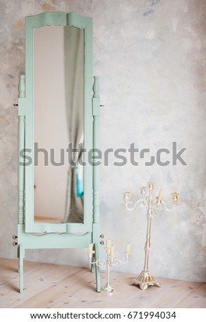 Stretched mirror in a wooden frame