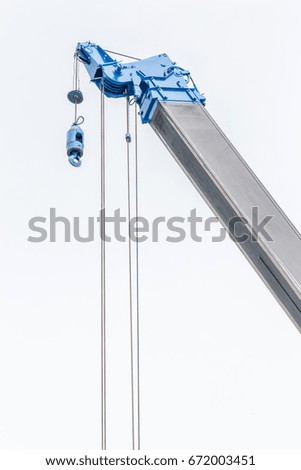 The blue construction crane for heavy lift using in construction industry with white background.