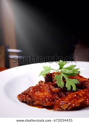 This is a classic american deep fried chicken wings .The picture of buffalo wings on white plate.  selective focus