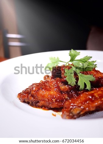 This is a classic american deep fried chicken wings .The picture of buffalo wings on white plate.  selective focus