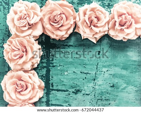 Postcard, background, rose flowers, laid out corner, on an old wooden background with cracks. Vintage hipster style. Artistic photo.
